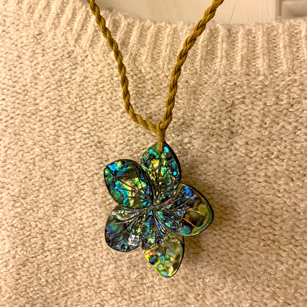 Beautiful carved shell flower necklace on braided cord. NWOT.